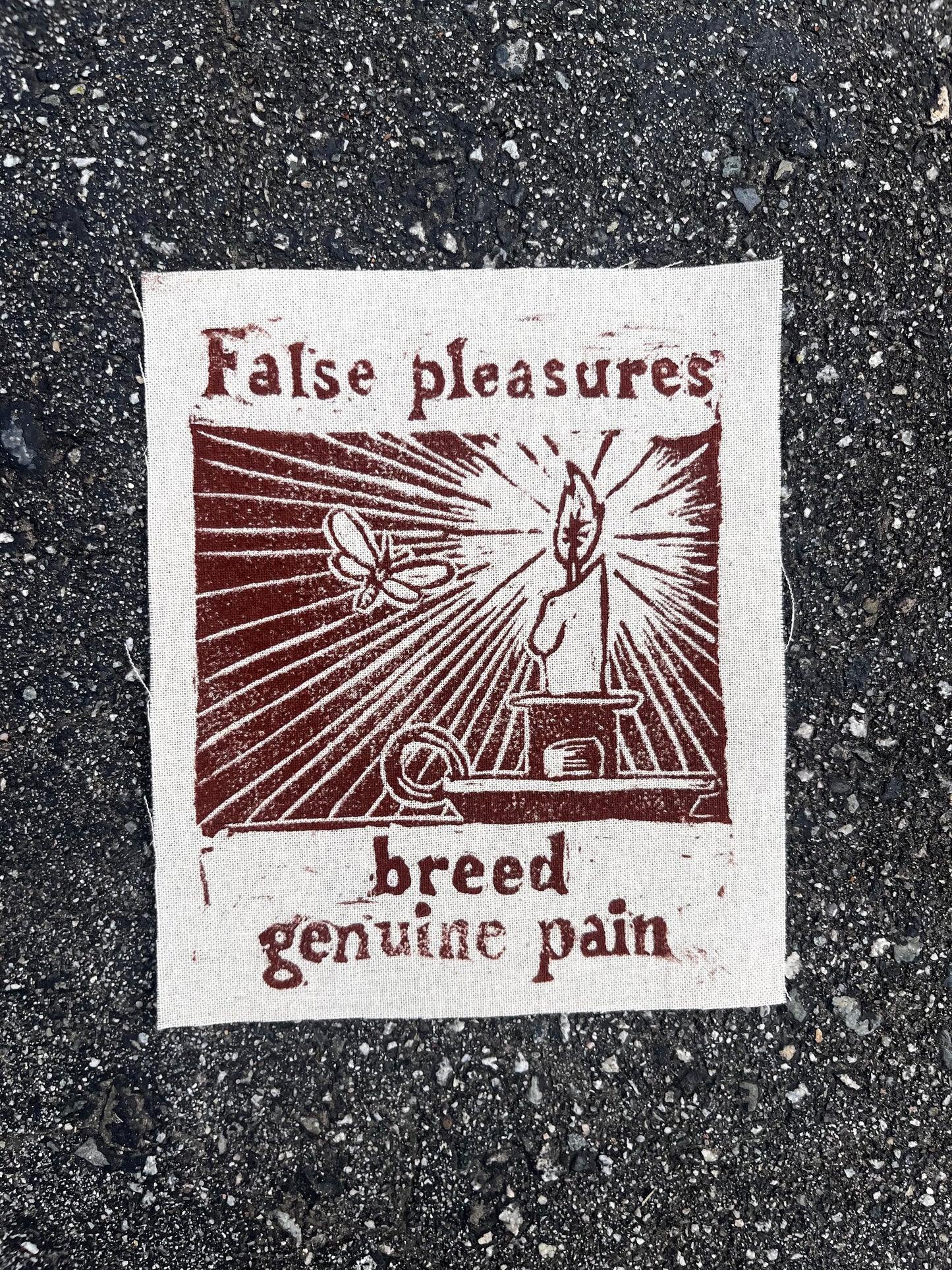 “false pleasures breed genuine pain” block print patch